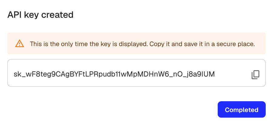 The API key created dialog showing the key value with a warning to copy it